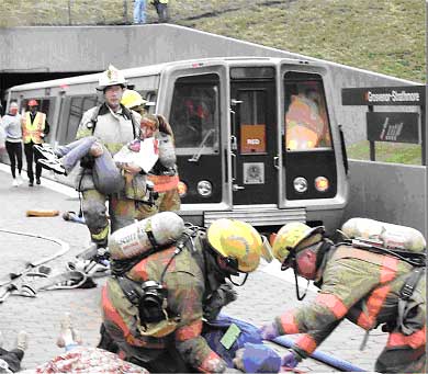 At a planned emergency drill, firefighters practice rescuing passengers from a Washington Metropolitan Area transit Authority subway car.
