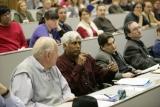 photo: Participant at U. of Minnesota meeting makes a point on health care issues
