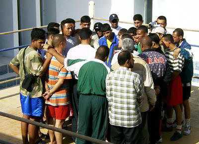 Iraqi Boxers form a team huddle to listen to Termite Watkins