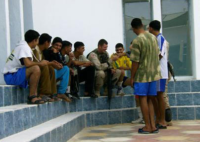 Member of the U.S. Army laughs with the Iraqi boxers