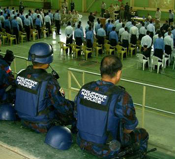 Members of the Philippine National Police look on. They are also involved with training the Iraqi Police