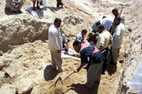 Local Iraqis examining remains. CPA photo