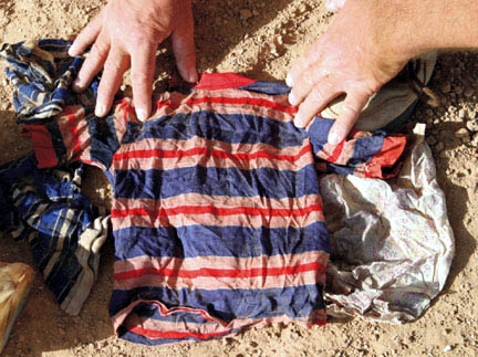 A child's garment found in a shallow grave. CPA photo. 