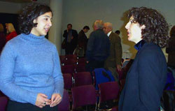 Commission Associate Director Dina Elani chats with Joanna Ramani a graduate student at Harvard