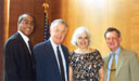 Executive Director Gerard Holder, Chairman Sarbanes of the Senate Banking, Housing and Urban Affairs Committee, Co-Chair Ellen Feingold and Commissioner John Erickson pause from conversation for a photo.